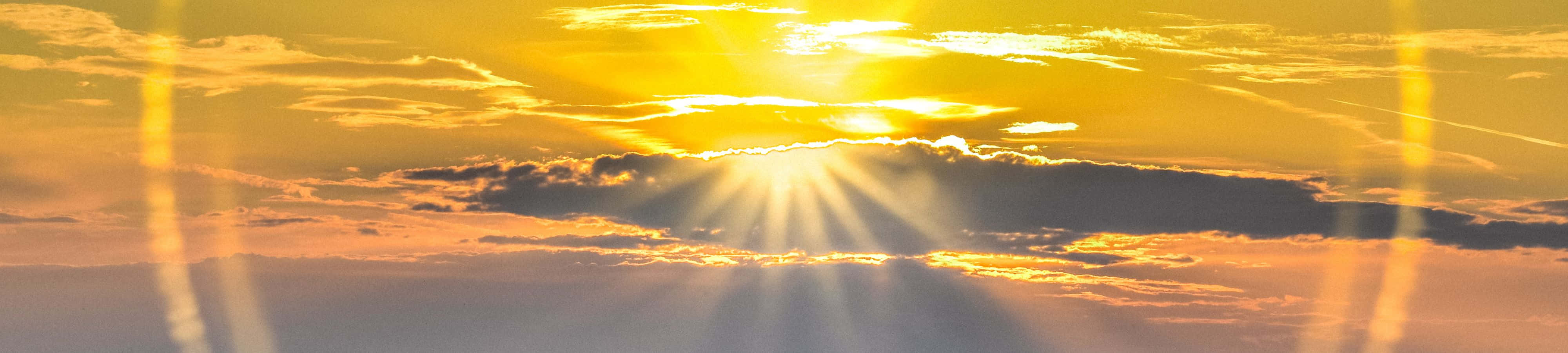 शांत जल पर एक राजसी सूर्योदय वॉलपेपर